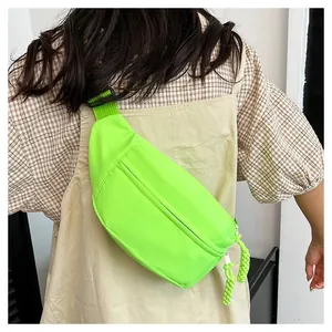 Detail of neon green canvas waist bag with adjustable strap worn by model from behind