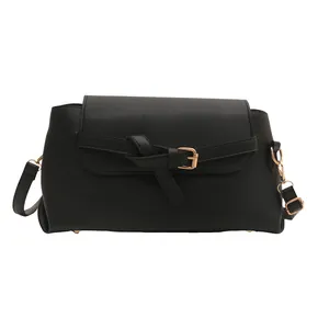 Classic black faux leather crossbody bag with knot detail and golden hardware