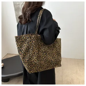 Detailed shot of leopard print canvas tote bag showing large capacity and shoulder strap