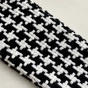 Detail of houndstooth tweed handle with gold metallic threads and woven texture