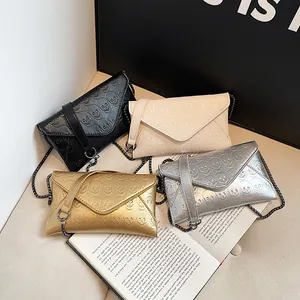 Fashion envelope chain bags in black, beige, gold, and silver with skull embossing