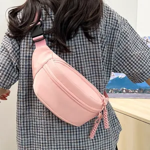 Pink lightweight crossbody waist bag with double zippers and woven cord details