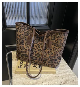 Close-up of leopard print tote bag featuring brown straps and high-quality texture