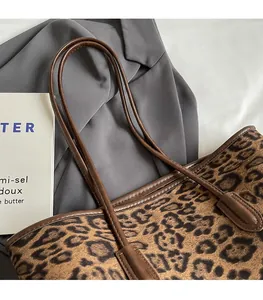 Detail view of durable leopard print tote bag straps and premium reinforced stitching