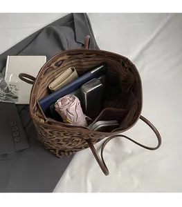 Top view of spacious leopard print tote interior showing storage for daily items