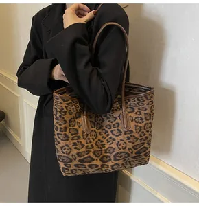 Close-up of a large leopard print tote bag with brown handles for daily commuting
