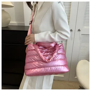 Close-up of pink padded metallic tote bag showing quilted texture and nylon strap
