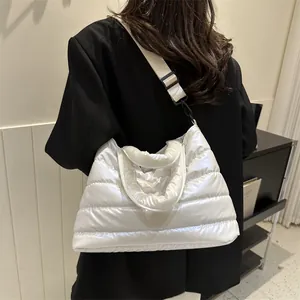 Chic white quilted puffer shoulder bag with glossy finish and wide strap for women