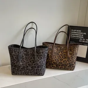 Large leopard print tote bags in black-grey and brown colors on marble surface