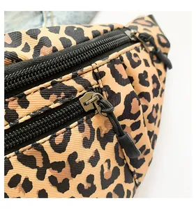 Detail shot of leopard print chest bag showing multiple zipper pockets and fabric texture