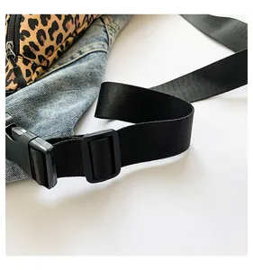 Close-up of leopard print nylon bag featuring black plastic buckle and adjustable strap