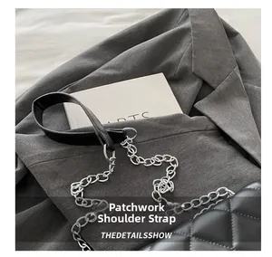 Detail showing the spliced shoulder strap made of black leather and silver metal chain