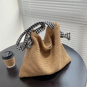 Minimalist straw woven tote bag with stylish houndstooth knot handles for beach vacation