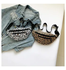 Detail showing two leopard print nylon fanny packs with adjustable straps and zip pockets