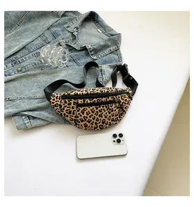 Detailed view of leopard print crossbody bag showing dual zippers and smartphone storage
