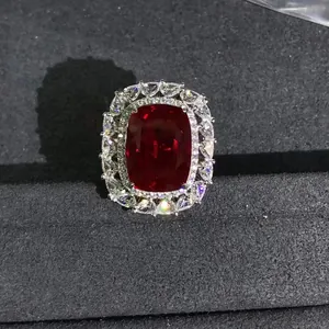 Macro shot of a 10-carat cushion-cut red ruby ring with sparkling diamond halo accents