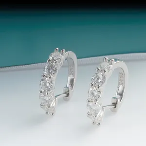 Close-up of S925 sterling silver hoop earrings with five sparkling round-cut moissanite stones