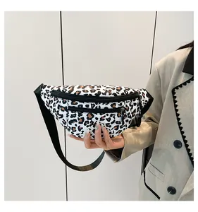 Macro shot of stylish leopard print fanny pack with durable black dual zippers and texture