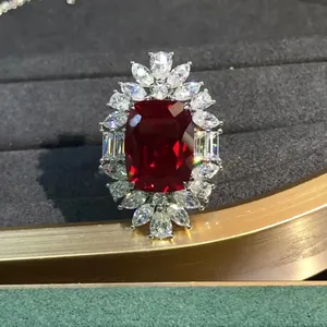 Macro shot of cushion cut red ruby ring with marquise halo in velvet jewelry box