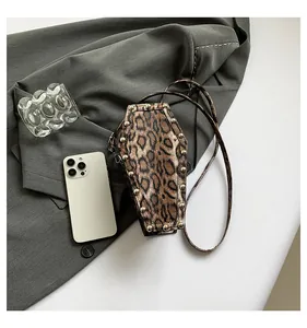 Detailed view of coffin shaped leopard print crossbody bag with silver rivet studs