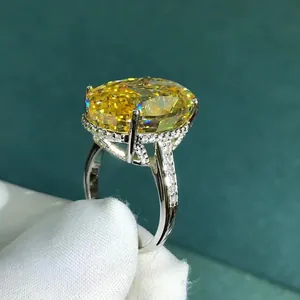 Macro shot of 30ct oval yellow gemstone ring with pavé diamonds and four-prong setting