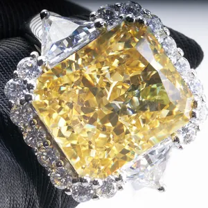 Macro shot of 10ct radiant cut yellow gemstone ring with halo and side stones