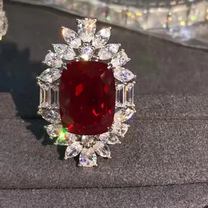 Luxurious silver ring with a large 10ct red cushion cut ruby and brilliant side diamonds