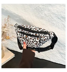 Detail of leopard print nylon chest bag showing double zipper pockets and adjustable strap