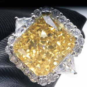 Macro view of a 10ct radiant-cut yellow stone ring with trillon-cut side diamonds