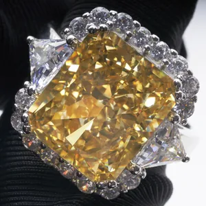 Macro shot of a 10ct radiant cut yellow gemstone ring with triangle side stones