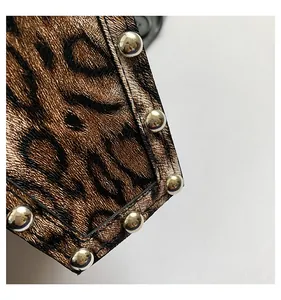 Detail of leopard print PU leather bag strap with round silver metal studs and stitching