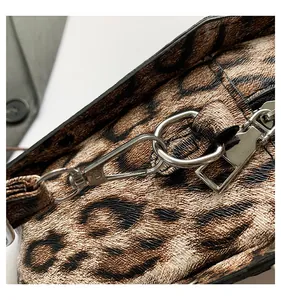 Macro detail of leopard print PU leather coffin bag with silver hardware and zipper
