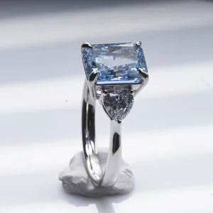 Radiant cut 3ct blue carbon diamond ring with heart side stones in silver claws