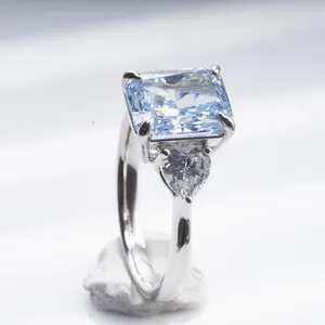 Radiant cut blue carbon diamond ring with silver band and side heart stones