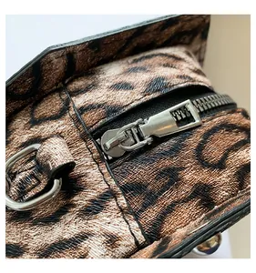 Close-up of leopard print PU leather bag showing silver zipper and metallic D-ring detail