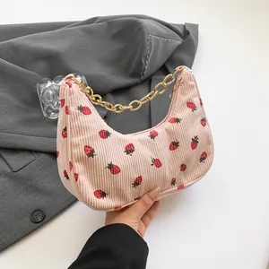 Pink corduroy crescent bag with strawberry print and gold chain strap for women