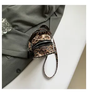 Close-up of leopard print mini round crossbody bag made of premium faux leather material