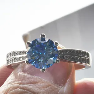 Royal blue moissanite silver ring with six-prong setting and pavé diamonds on the band