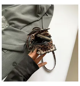 Close-up of leopard print PU leather crossbody phone bag with silver studs and metal zipper