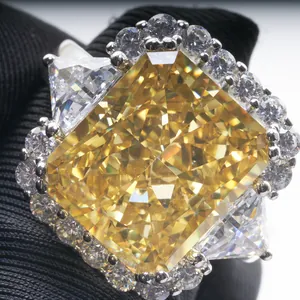 Luxurious radiant cut yellow high carbon diamond ring with side stones on black fabric