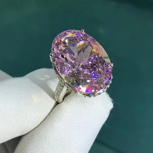 Luxurious 30ct oval pink carbon diamond ring with 3EX cut stones in a micro-pave setting