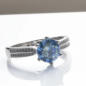 Royal blue moissanite ring with six-prong setting and pavé side stones on silver band