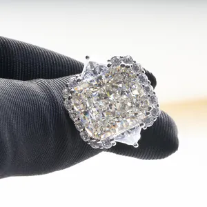 Macro view of radiant cut carbon diamond ring with side stones and halo design