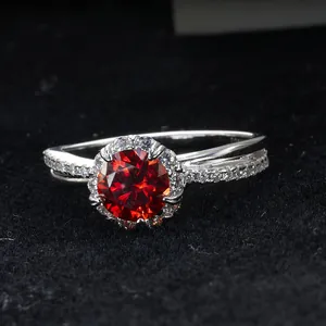 Macro shot of 925 sterling silver ring with a red moissanite and halo setting