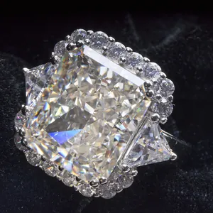 Macro view of radiant cut carbon diamond ring with halo setting and side stones