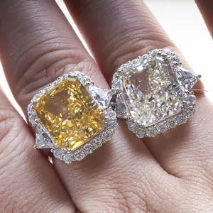 Macro detail of high carbon diamond rings with cushion-cut yellow and white halo settings