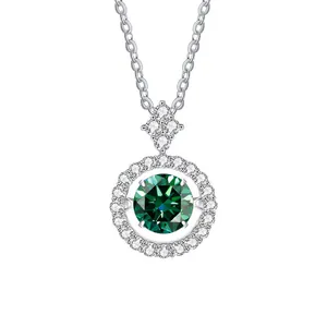 Macro detail of silver necklace featuring round green gemstone with halo diamond border