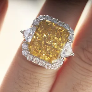 10 carat radiant cut yellow diamond ring in 925 silver setting with halo detail