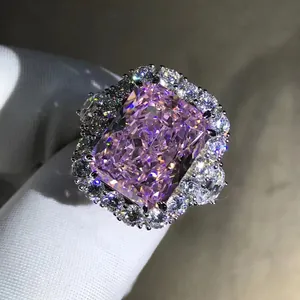 Macro shot of 10-carat radiant cut pink stone with double halo diamond setting on silver ring
