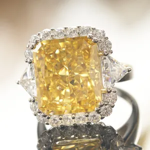 Macro detail of radiant cut yellow gemstone ring with silver band and micro-pave halo